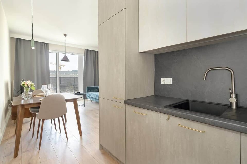 A wide view of the dining and kitchen area, highlighting the open-plan layout and cohesive modern design.
