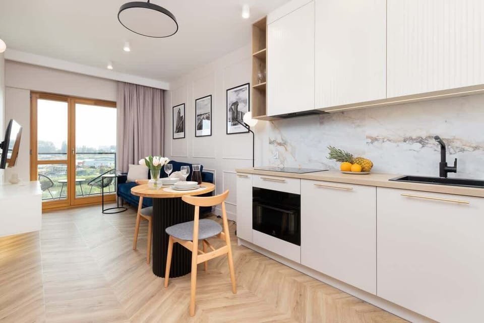 Bright kitchen with cooking utensils. 