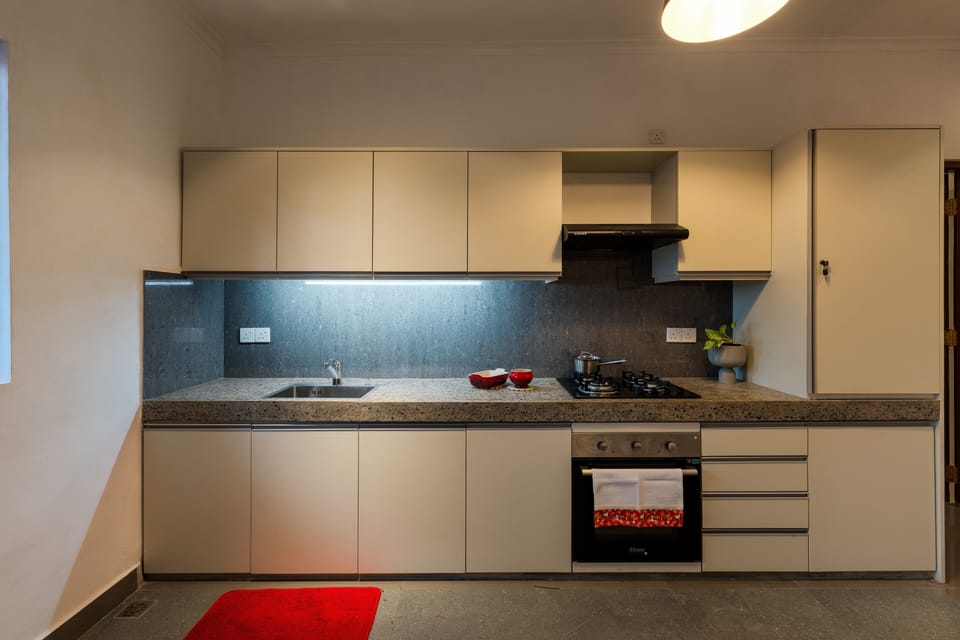 Ground floor indroor kitchen ,  gas stove top , fridge , microwave etc