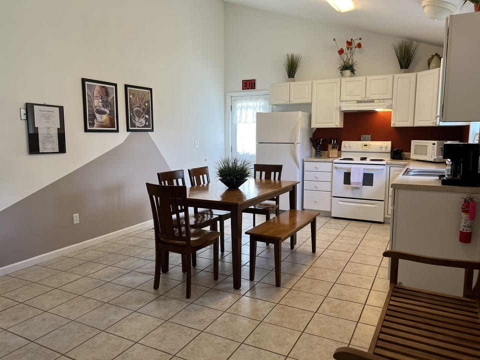 The Federal House Apartment 2 dining  table with seating for six. The exit door on the  left leads to the back deck and grill area.