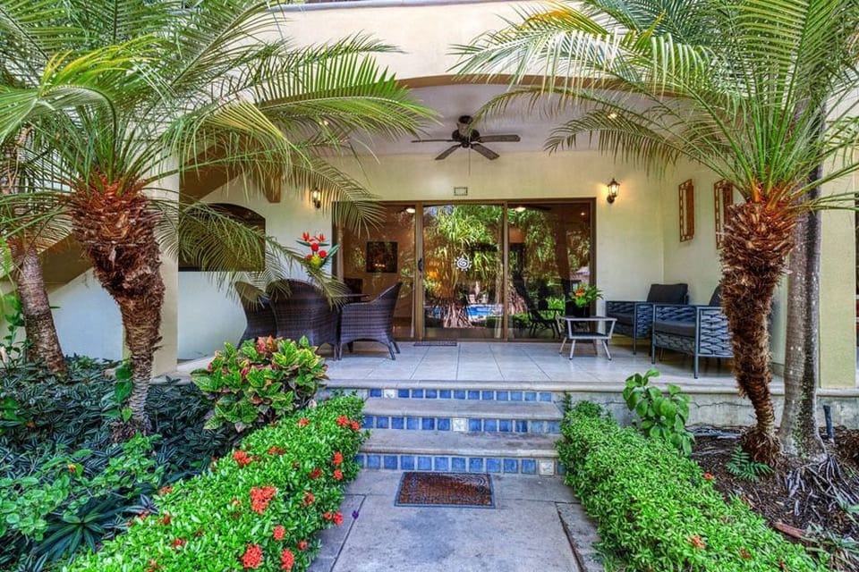 Covered deck with table and chairs, 15 feet from the pool.