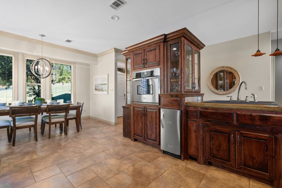 The kitchen boasts an under-counter ice maker and ample counter space.