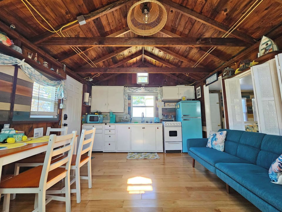 Kitchen and Dining Room with Retro-Fridge, Micro, Keurig, and new flat-top Stove, sofa sleeper. The original wood rafters from 1949 are perfectly preserved.
