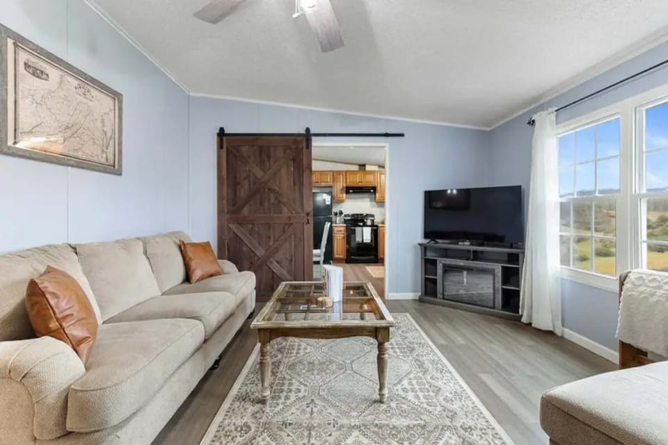 Living room can be separated from kitchen via a sliding barn door.