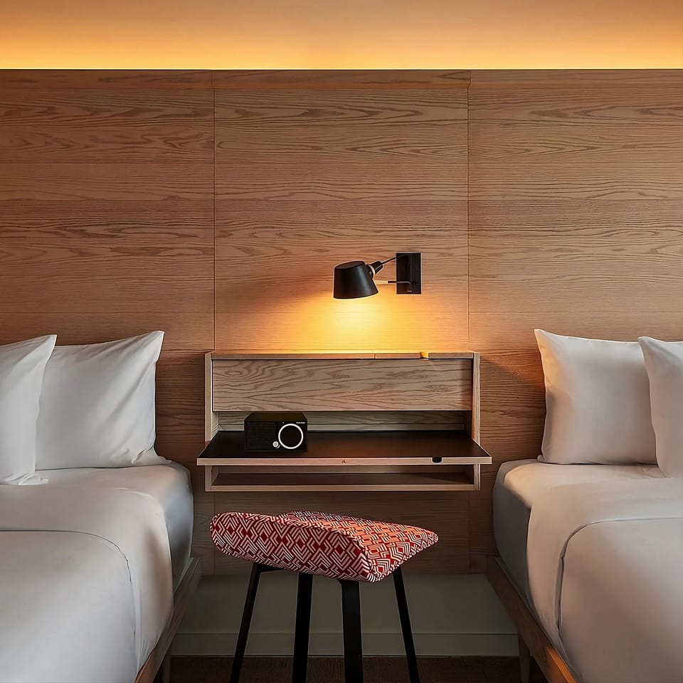 Enjoy a quiet moment between beds with warm reading light.