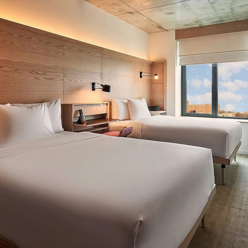 Drift off beside city views and soft, ambient lighting.