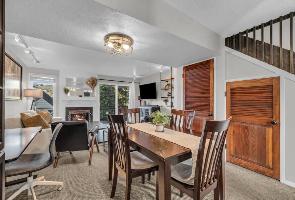 The dining table includes seating for 4 and is situated right next to the kitchen making it convenient to bring hot dishes right to the table for a family-style meal.