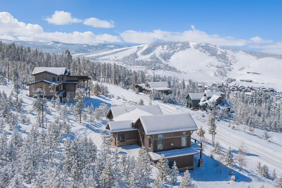 Aerial view of the home and property with some of the Granby Ranch slopes in the background
