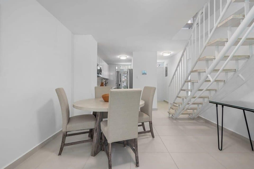 The dining table seat 4 guests and it is right besides the kitchen and living room.