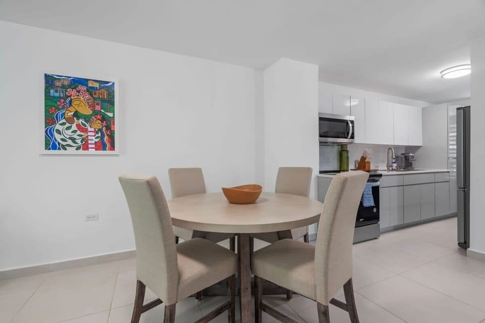 The dining table seat 4 guests and it is right besides the kitchen and living room.