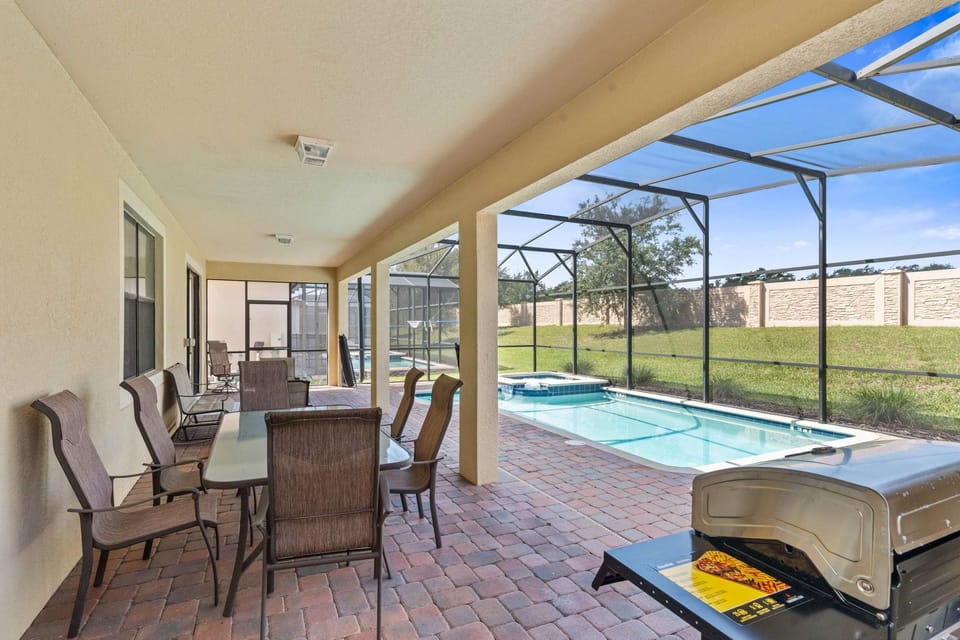 The outdoor dining area at Vista Cay Resort boasts a BBQ grill, providing guests with the perfect setting to enjoy delicious meals by the pool, creating cherished moments of relaxation and culinary delight.