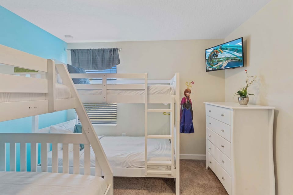 Bedroom 3 at Vista Cay Resort boasts three single beds and one double bed, providing ample space to rest and recharge after a day of adventure.