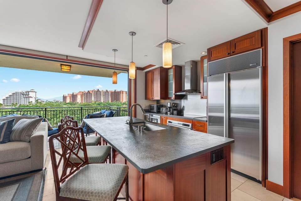 Cook with style in your gourmet kitchen featuring granite counters, stainless appliances, and stunning city views from your private balcony.