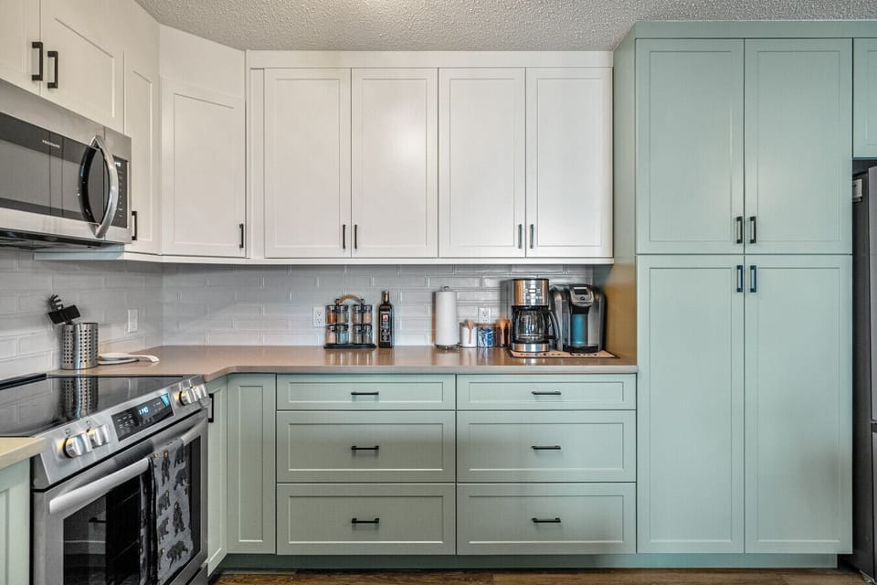 Fully redone kitchen with a drip coffee maker, ground coffee, tea, sugar, and basic condiments (ketchup, mustard, and relish.)