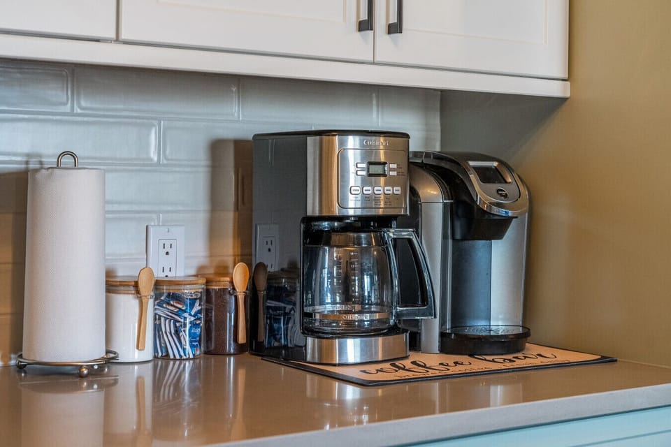 Fully redone kitchen with a drip coffee maker, ground coffee, tea, sugar, and basic condiments (ketchup, mustard, and relish.)