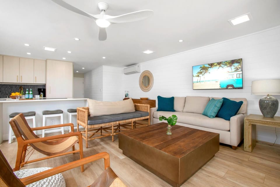  Shiplap walls whisper nautical tales while wicker chairs nod along, sipping sunlight like morning espresso  