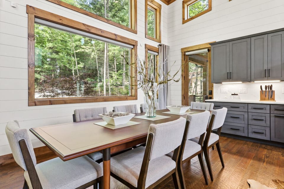 Indoor dining table adjacent to kitchen and grilling area