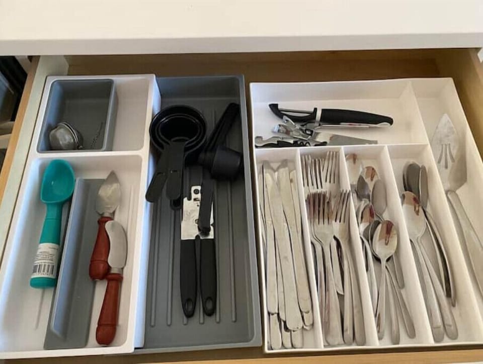 Plenty of utensils, can opener, measuring cups, tea diffuser, peeler