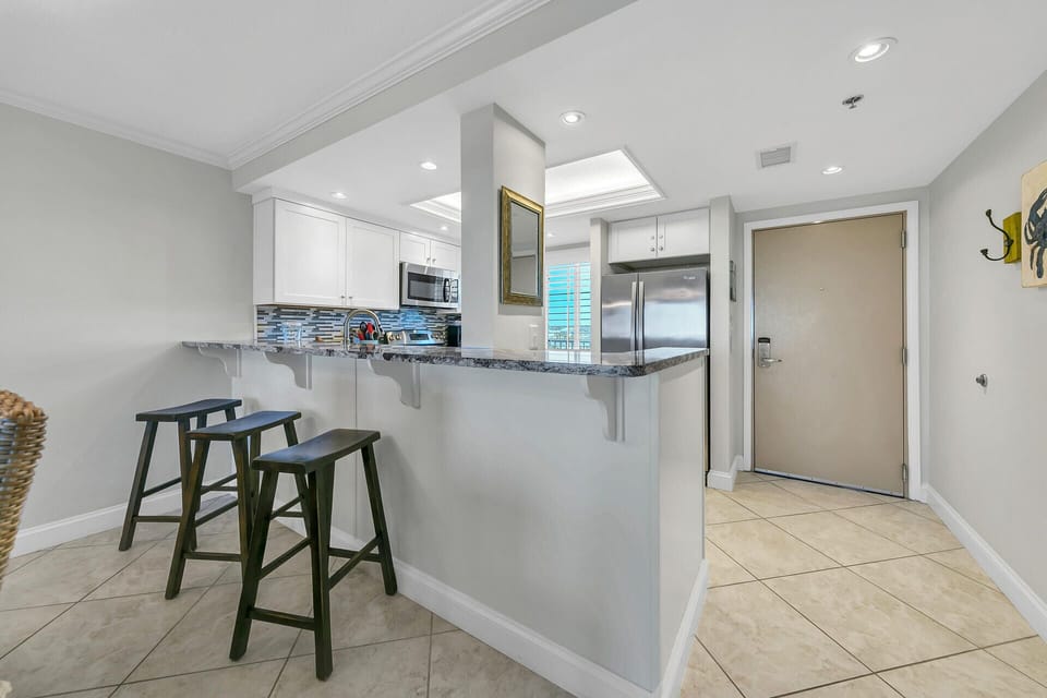 Your stylish kitchen features granite counters, stainless steel appliances, and breakfast bar seating for casual meals and coffee breaks.