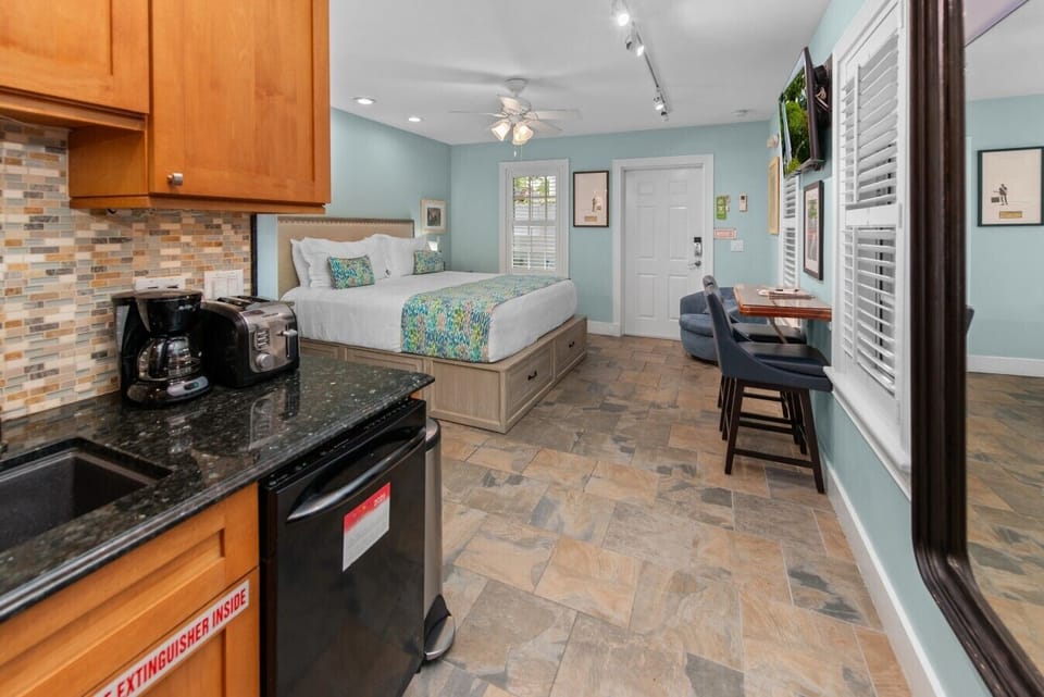 A full length mirror, dishwasher, coffee makerm, toaster in the kitchen.