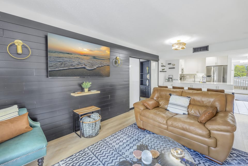 Living area sunny, opens to private balcony with bay view.