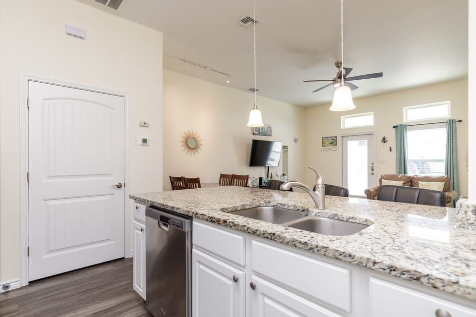 Your gourmet kitchen features granite countertops and modern appliances, flowing seamlessly into the dining and living areas for perfect entertaining.