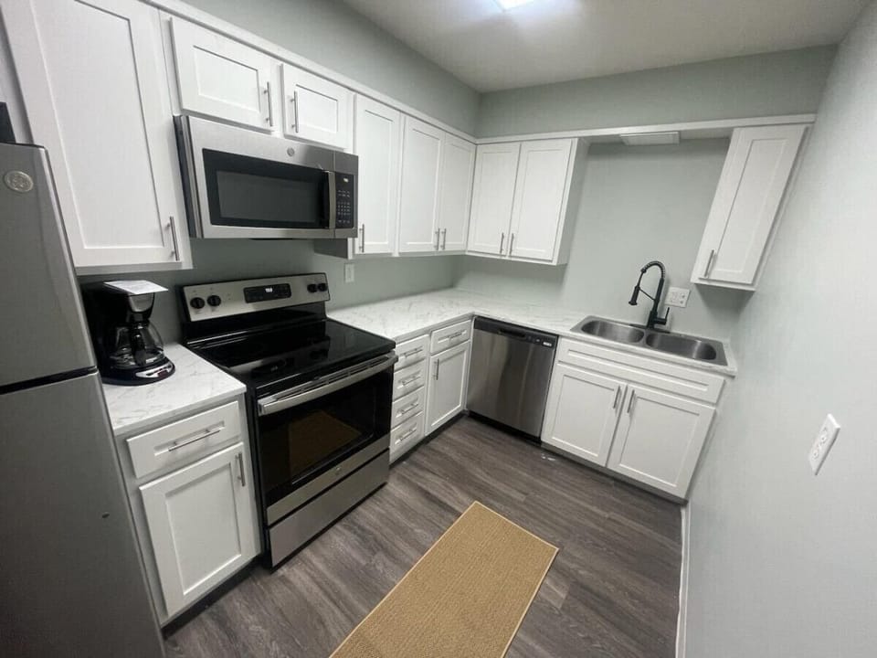 Modern kitchen featuring stunning stainless steel appliances and chic white cabinetry, for preparing delicious meals.