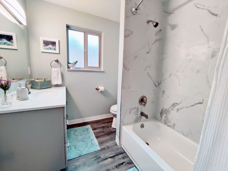 A clean bathtub, a sleek toilet, and a stylish sink  is always inviting for a cool shower.