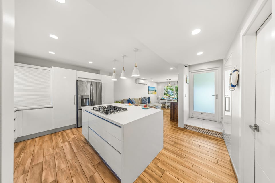 Open-plan kitchen with modern appliances, a central island, and stylish decor.