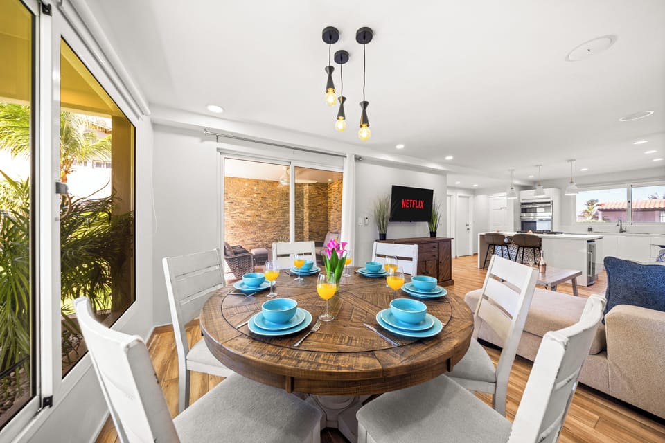Dining space with a wooden table, elegant decor, and outdoor views