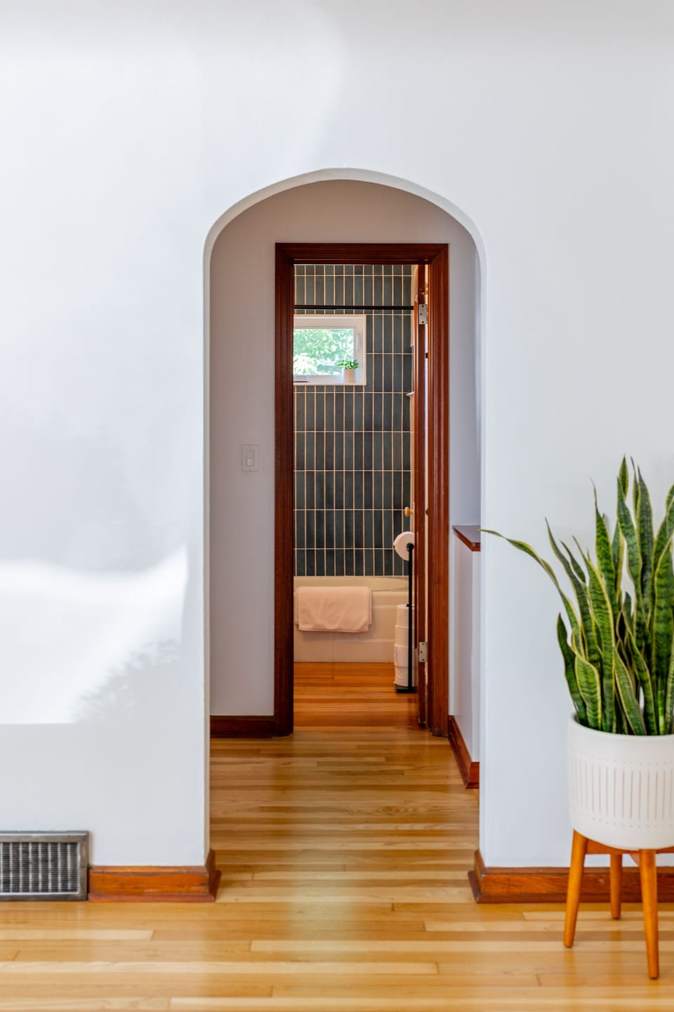 Looking from the front entry way into the upstairs bathroom.