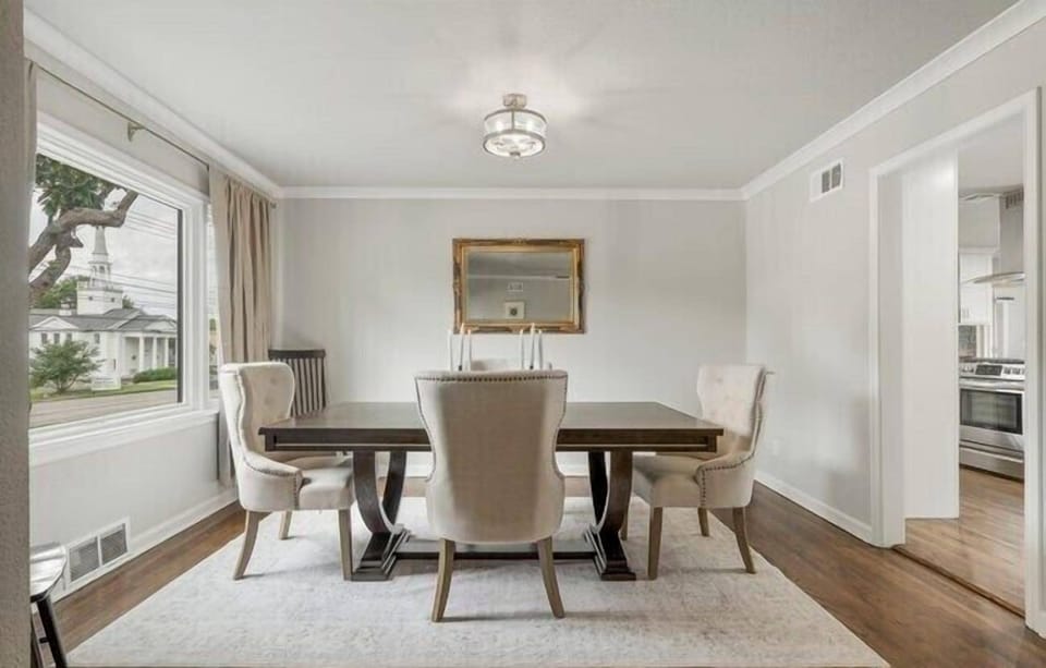 Dining table sits in front of a huge picture window.