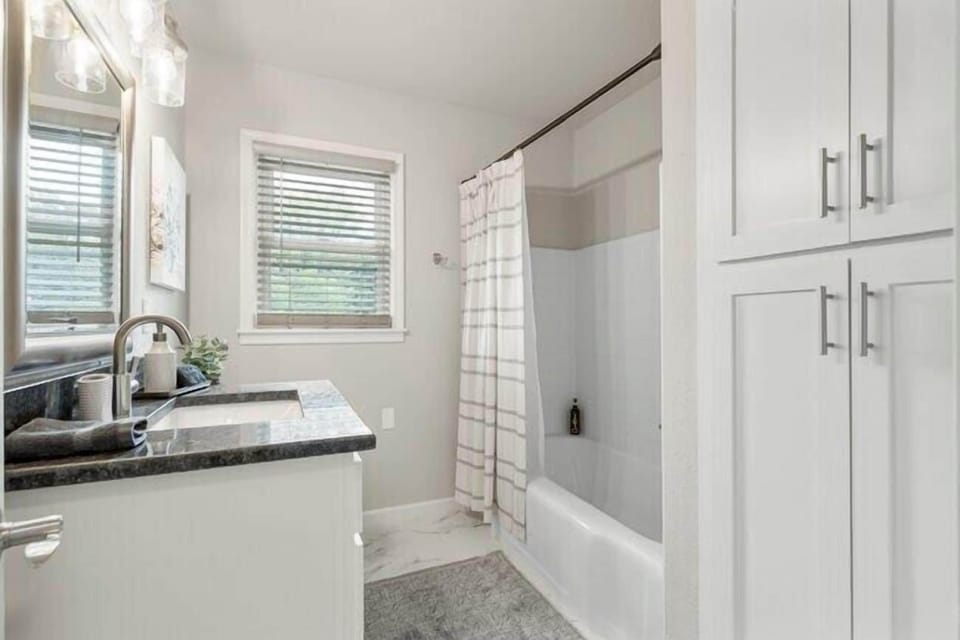 Full Hall bath has large cabinets for storage and lots of thick, fluffy towels.