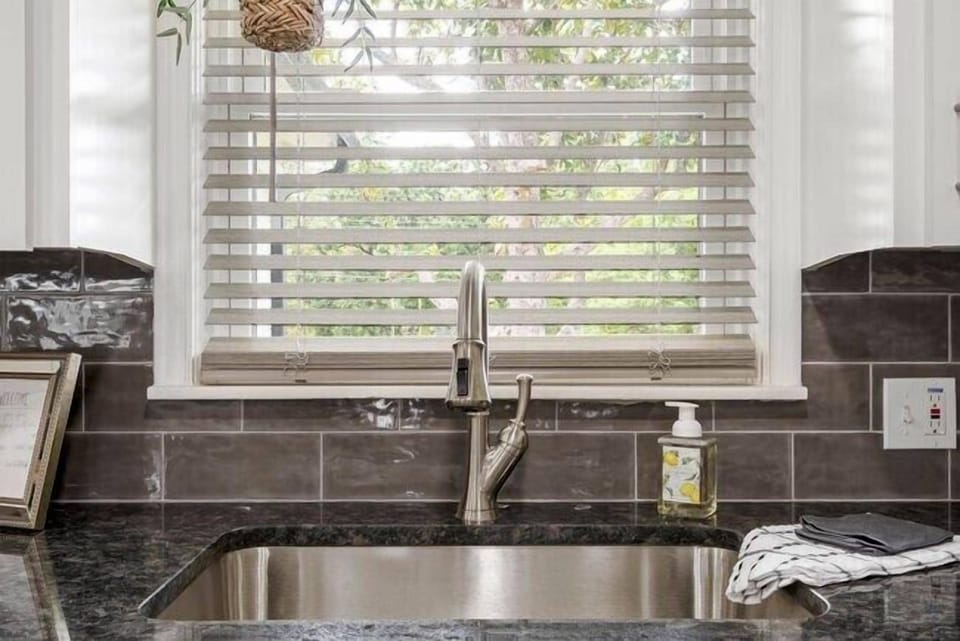 Beautiful faux-wood blinds adorn all the windows so you can enjoy the sunlight or darken the room if you prefer.