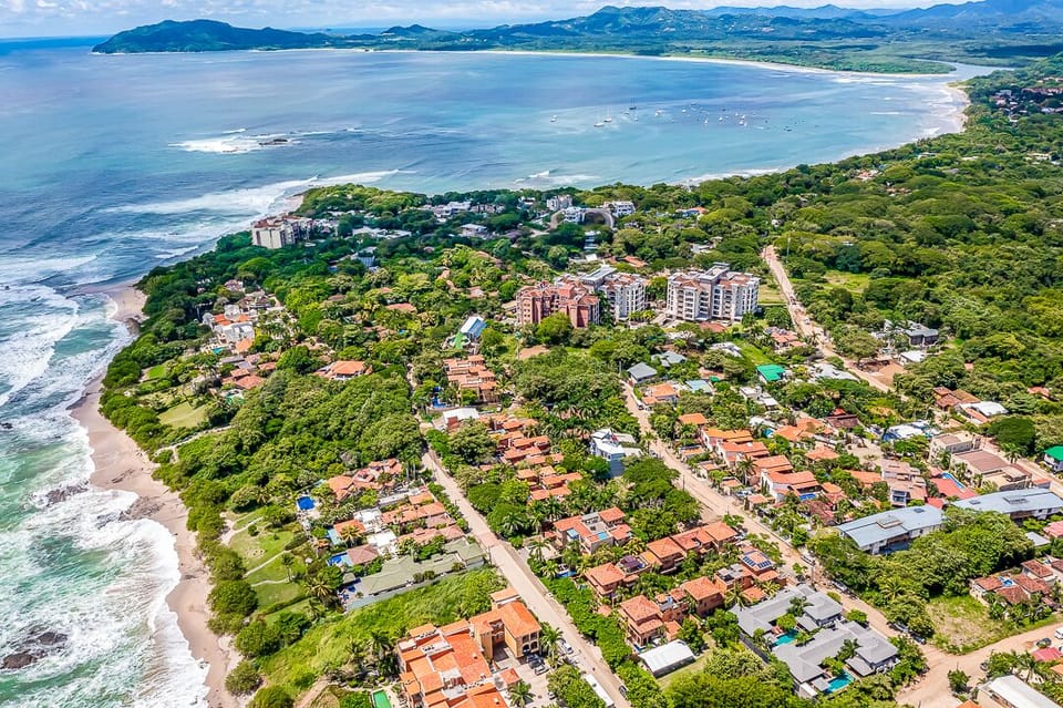 Aerial view of Langosta Beach and its surroundings in Tamarindo, showcasing Langosta Village, nearby Tamarindo Beach, and downtown in the background. Perfectly located for easy beach access, local dining, and a luxury Costa Rica vacation.