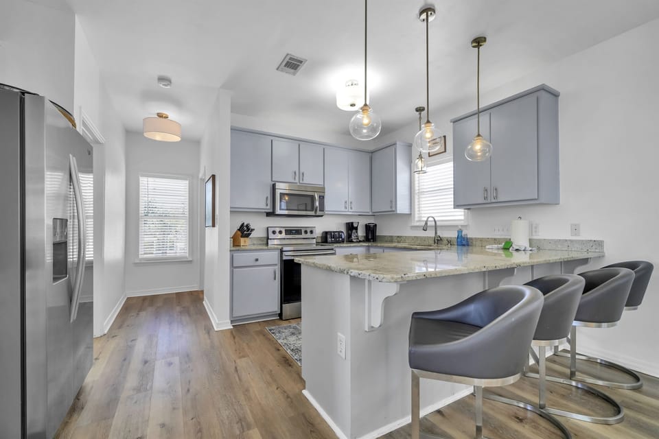 Four extra barstools at the kitchen counter are perfect for guests to enjoy meals
