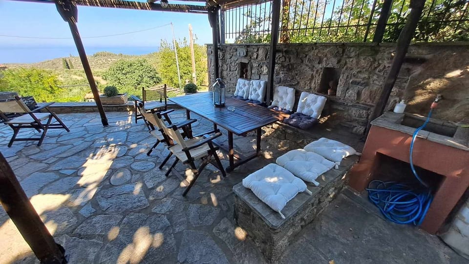 Exterior dining room with Barbeque and built-in sink, captured in the morning 