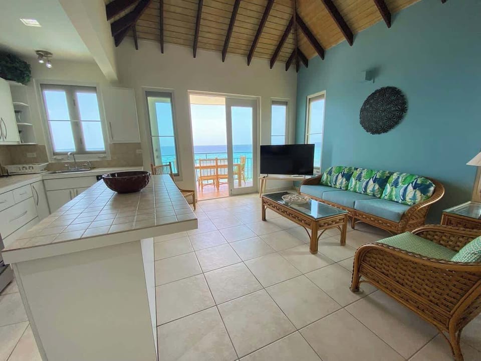 Open plan living area showing kitchen and kitchen island. 