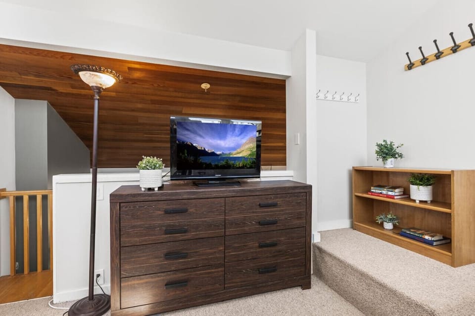 Open wall of bunk room loft, looking over to great room and stairway