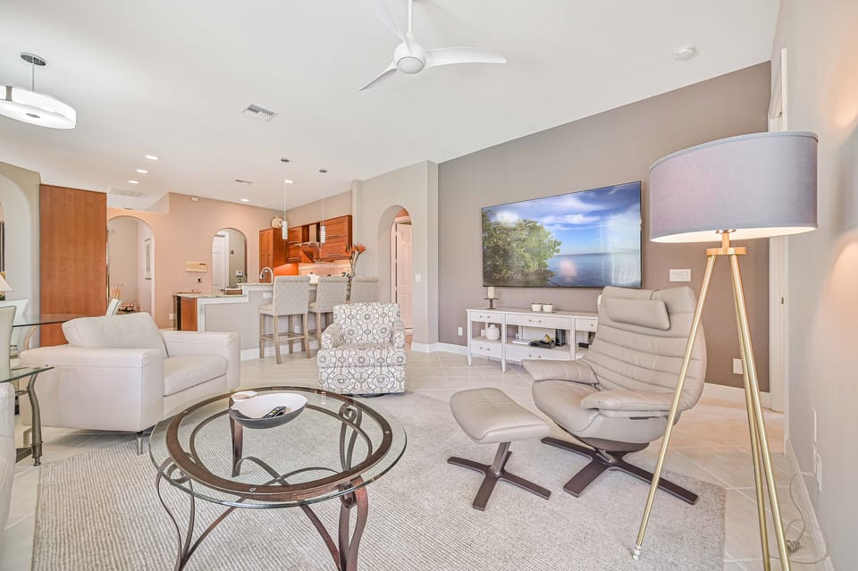 Olivia - Family room with large flat screen TV and sliding doors opening up to the pool area