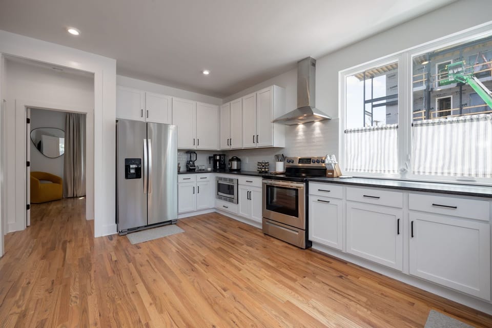 2nd Floor: Fully equipped kitchen boasting stainless steel appliances and stocked with all culinary essentials.