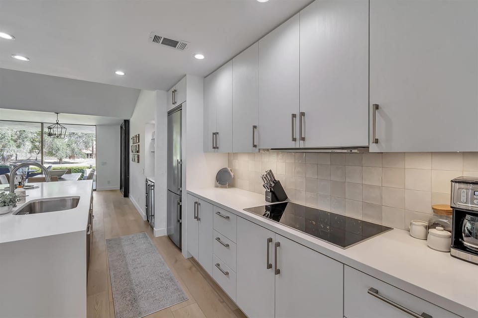 Kitchen: open and bright, well stocked with cookware, dishware and silverware.