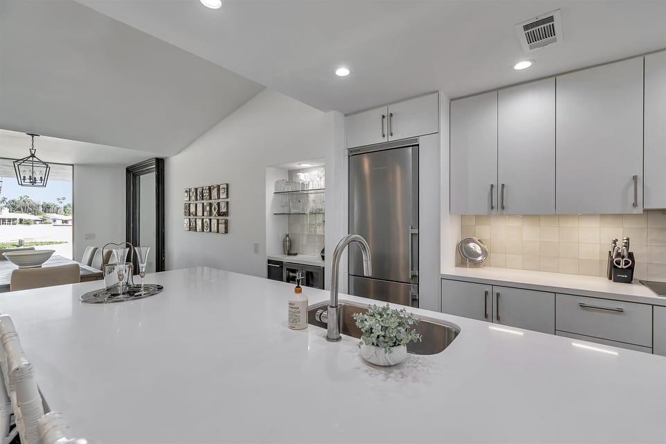 Built in Bar: glassware, Ninja blender and wine & beverage refrigerator.