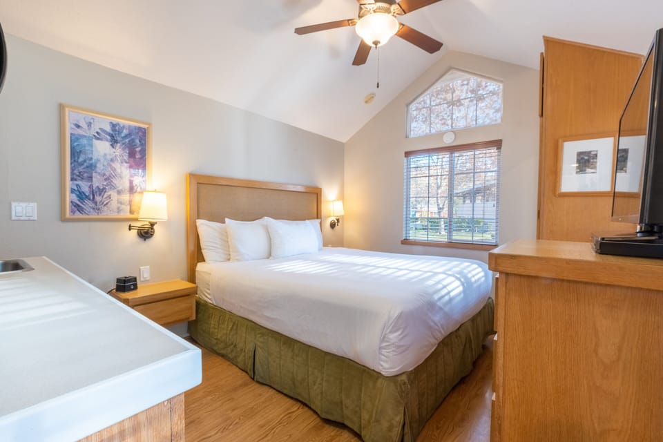 Sink into a plush king bed beneath airy vaulted ceilings.