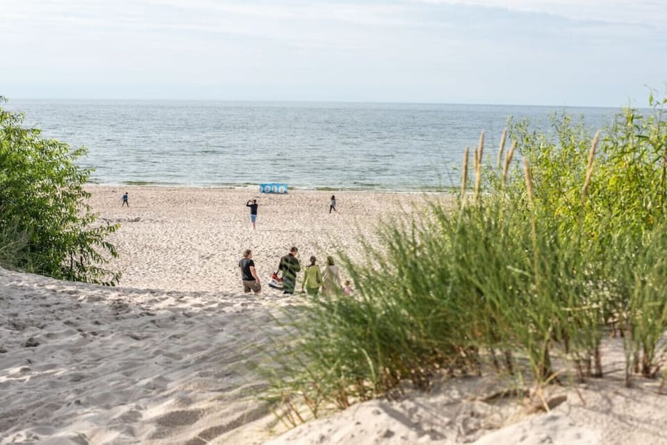 Entrance to a wide sandy beach – apartment nestled right by nature.