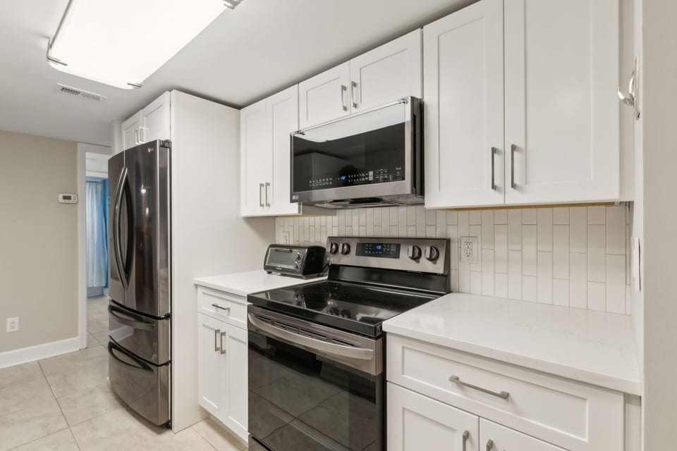 Fully Renovated Kitchen with Open Shelving, Gorgeous Quartz Countertops, and Stainless Steel Appliances