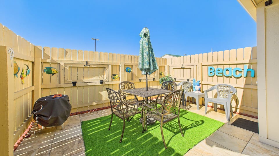 Patio with dining table and lush coastal themed decor