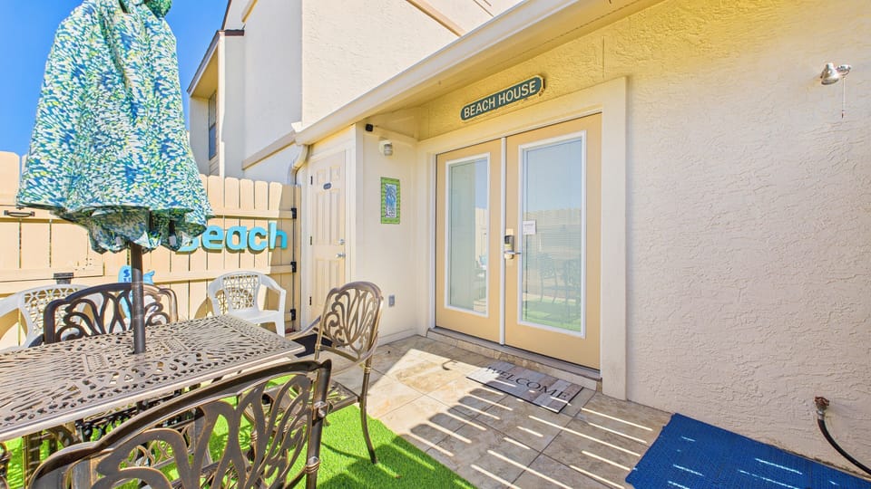 Patio with dining table and lush coastal themed decor