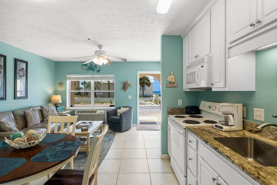 Bright, functional kitchen flowing into the living space — easy for cooking & entertaining.