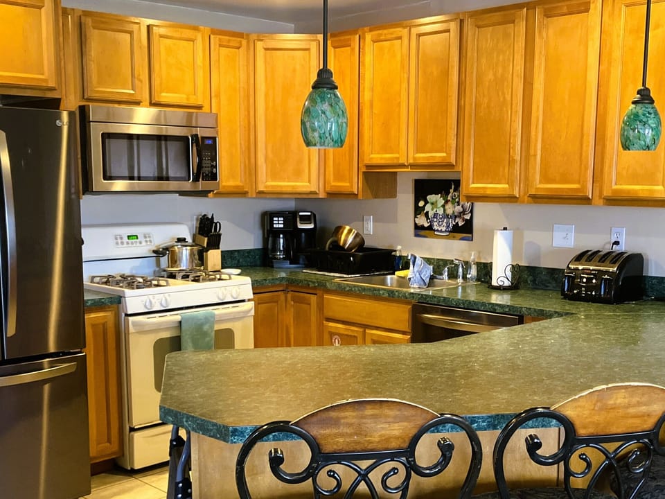 Nicely equipped kitchen with seating for five at the breakfast bar.